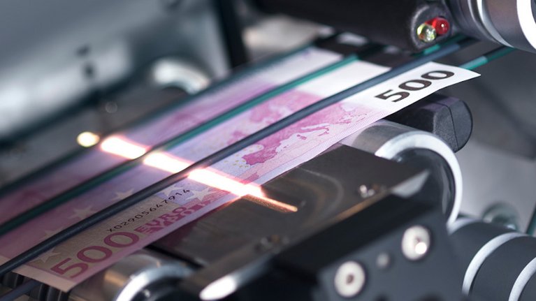 Ein 500€-Schein wird in einer Maschine durchleuchtet und untersucht
